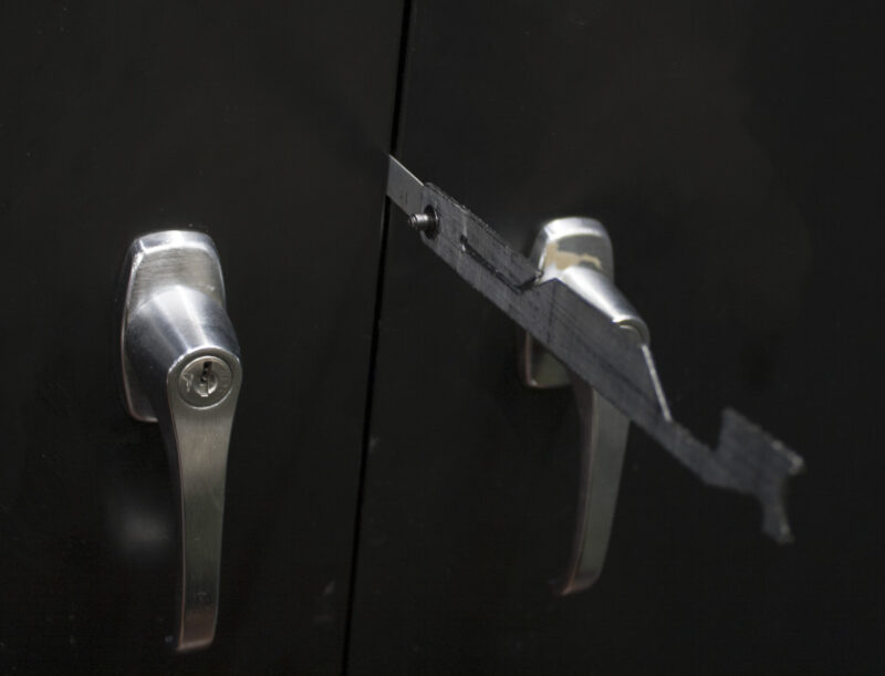 Black Hills Designs - SHOVE-R cutting through the locking hasp of a cabinet